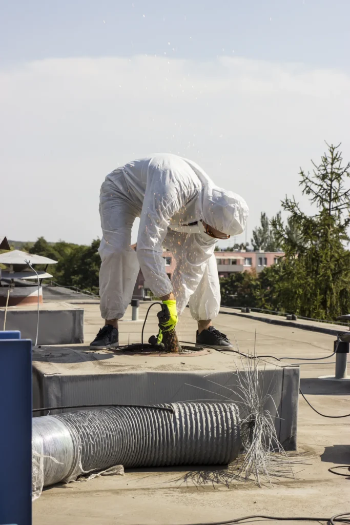 Technik spúšťa čistiace zariadenie do vetracieho potrubia na streche